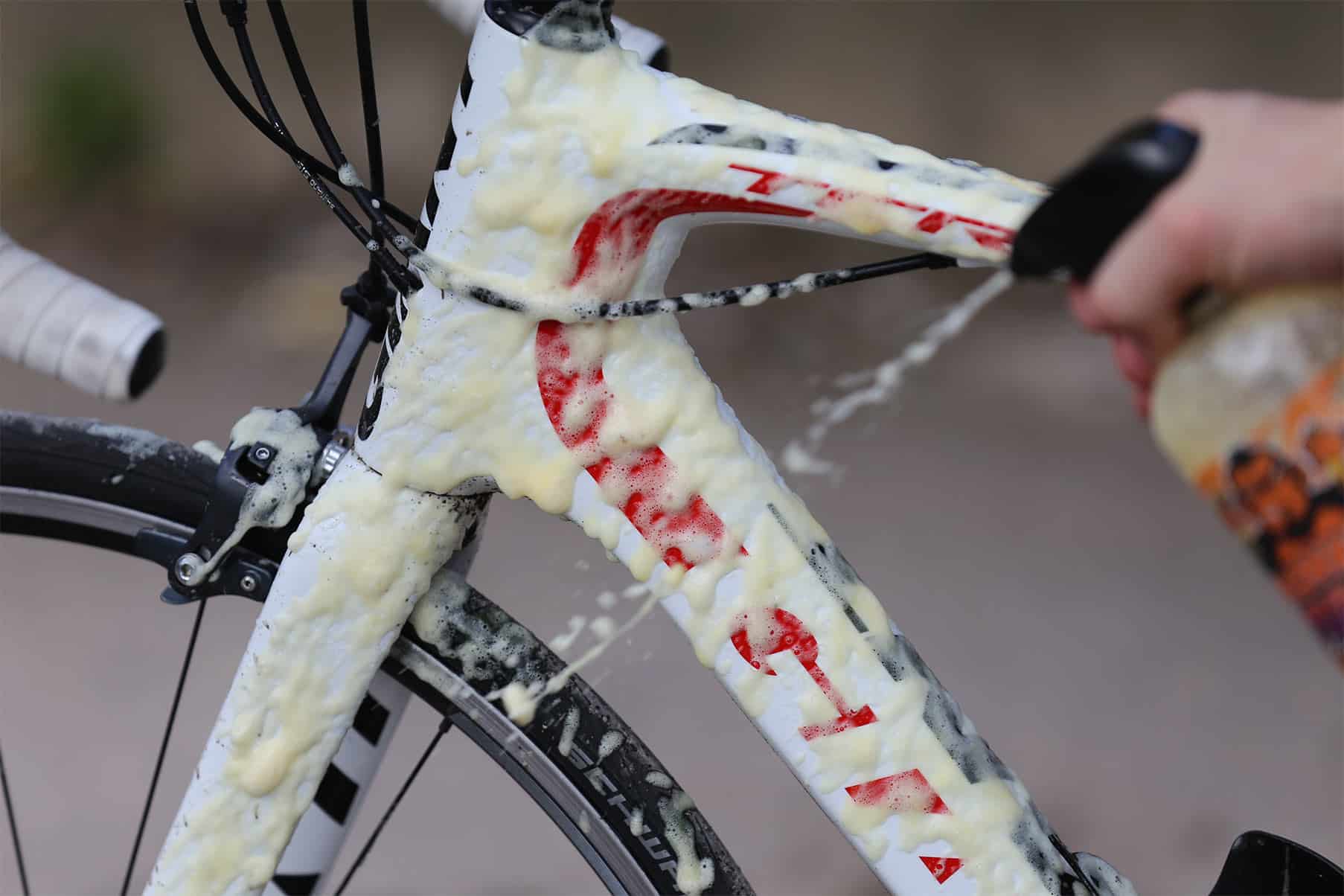 Person cleaning bike with Tru-Tension's Gel Bike Cleaner